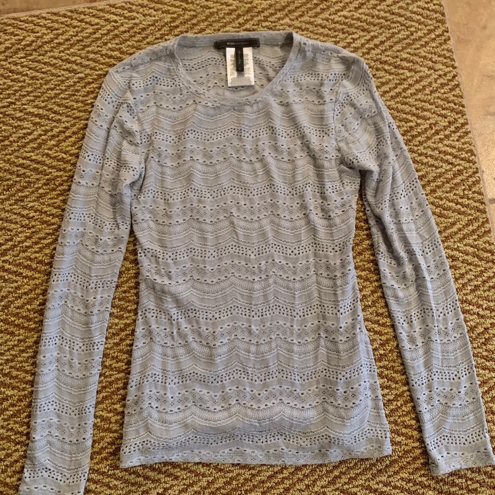 Light blue sweater with intricate hole details